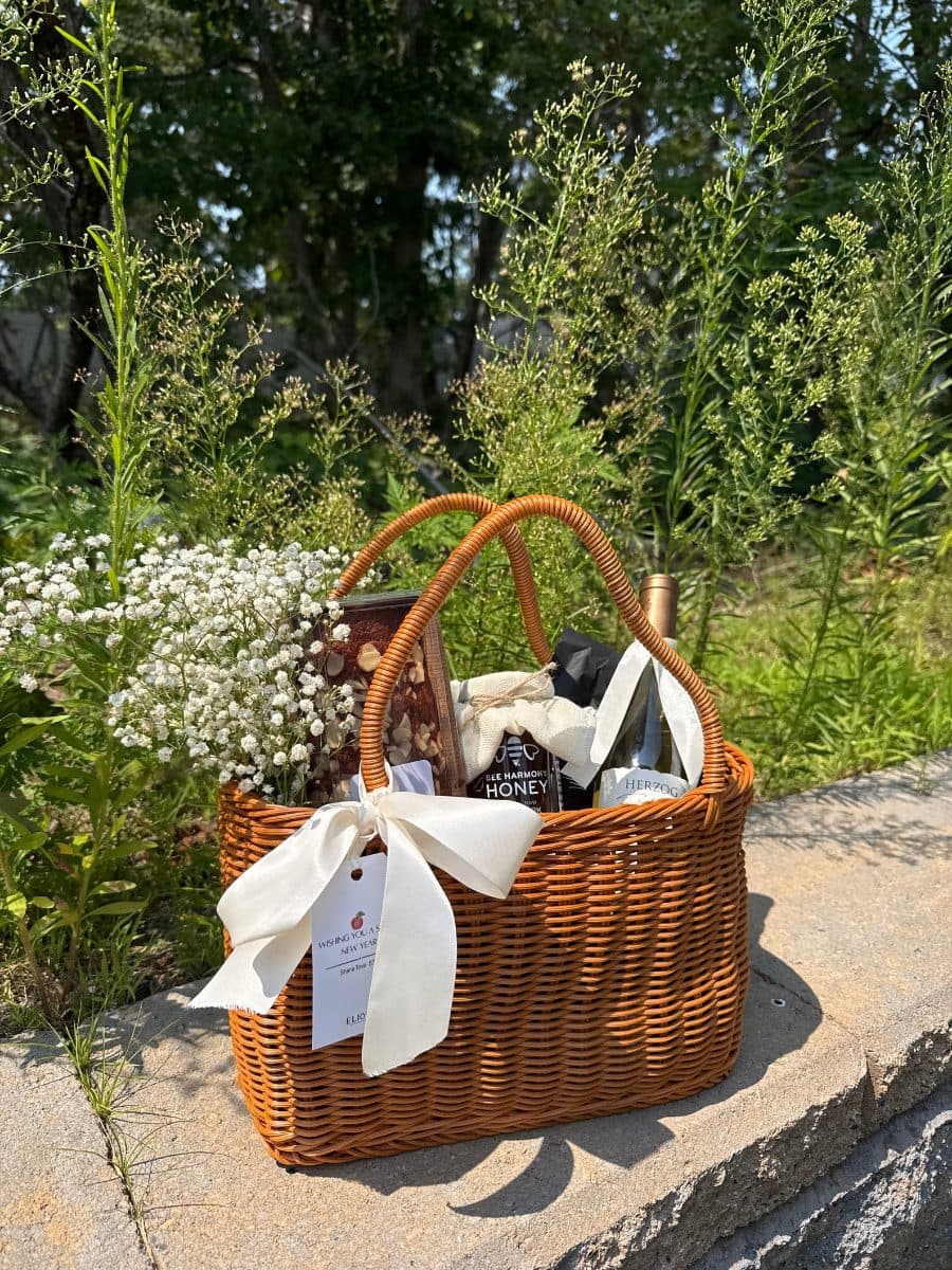 The Classic — a wicker basket of Herzog wine, honey cake, premium honey and baby’s breath, tied with a cream ribbon